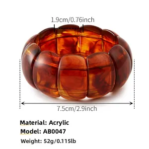 Detail of amber tortoiseshell acrylic bracelet showing 1.9cm width and resin texture