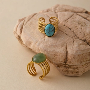 Detail of vintage bohemian wide rings with turquoise stones and gold multi-layer bands