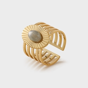 Detail of vintage gold wide open ring with sunburst design and oval gray gemstone