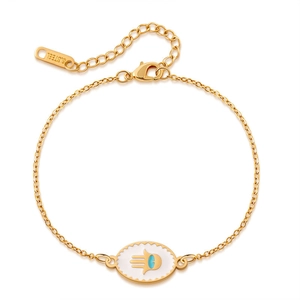 Detail of gold-plated stainless steel Hamsa hand bracelet with blue evil eye charm