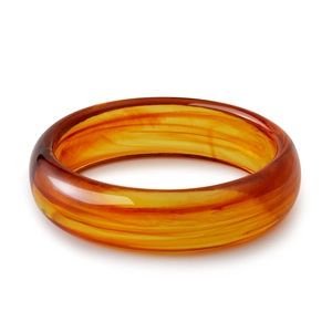 Detailed macro view of bohemian amber acrylic bangle with tortoiseshell texture pattern