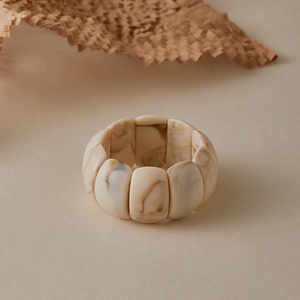Detailed macro view of retro marble patterned acrylic cuff bracelet with brown ink swirls