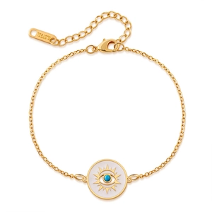 Detailed macro view of gold plated stainless steel Evil Eye charm on a fine link chain