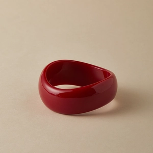 Detailed view of the wavy red marble texture acrylic bangle with glossy finish