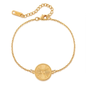 Detail of gold stainless steel bracelet featuring sunburst disc pendant and lobster clasp