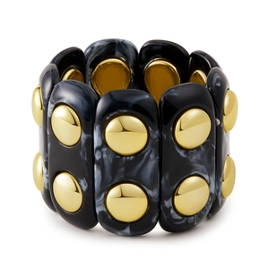 Dettaglio del bracciale elastico largo in acrilico con trama marmorea e borchie
