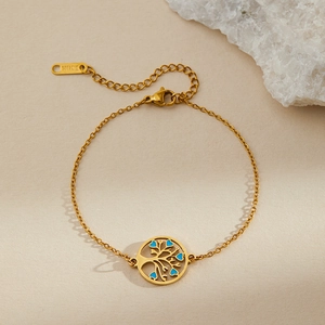 Detail of gold stainless steel bracelet featuring Tree of Life charm and blue heart charms