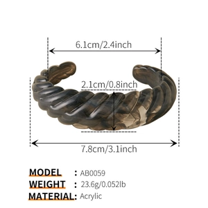 Detail view of wavy acrylic bangle in brown tortoiseshell with specific size measurements