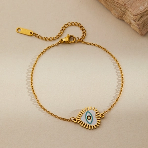 Detailed shot of golden heart evil eye bracelet with sunburst spikes and adjustable chain