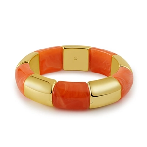 Detail of orange marble resin segments and gold metallic blocks on a stretch bracelet