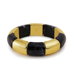 Close-up of vintage stretch bracelet with gold metal blocks and marble resin texture
