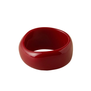 Exaggerated chunky red acrylic bangle with irregular round texture and high gloss finish