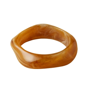 Vintage irregular geometric resin bangle with amber marble texture on white background