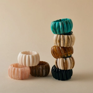 Stacked wide ribbed resin bangles in marble, amber, and solid tones for a vintage look