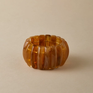 Close-up of amber acrylic chunky bangle with marbled vintage texture and elastic band