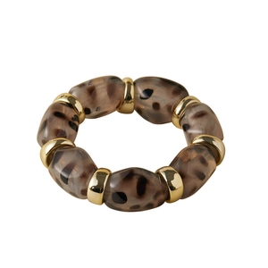 Close-up of leopard print resin beads and gold spacer rings on an elastic bracelet