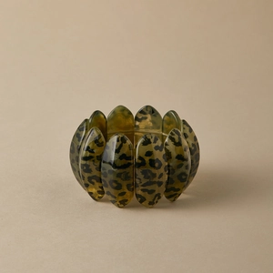 Close-up of leopard print resin stretch bracelet with translucent amber oval beads