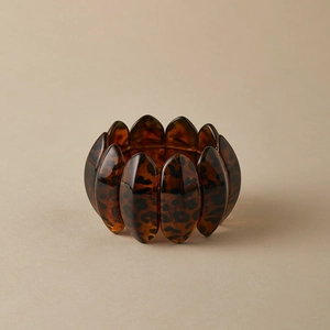 Detailed view of elastic leopard print acrylic bracelet with polished resin plates