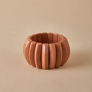 Macro view of a wide elastic bangle with vintage Maillard style oval pink resin tiles
