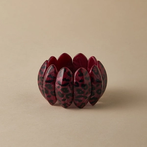 Macro shot of wide acrylic stretch bracelet with burgundy agate and leopard print texture