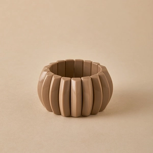 Detail of stacked taupe geometric resin cuff bracelet with a smooth matte finish