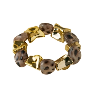 Macro detail of acrylic leopard print beads and irregular golden metallic bracelet elements