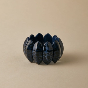 Close-up of elastic wide stretch bracelet with deep blue marbled leopard resin texture