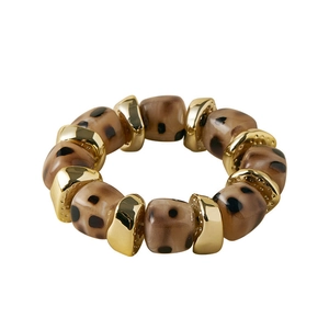 Detail of bohemian acrylic leopard print beads and polished gold metal beads on a bracelet