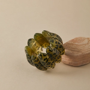 Macro shot of leopard print acrylic stretch bracelet on natural stone background
