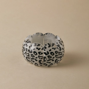 Macro shot of wide leopard print elastic bracelet with acrylic semi-circle modules