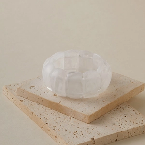 Detail of chunky cream resin stretch bracelet showing marbled texture and geometric links