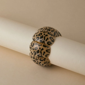 Detail of wide leopard print resin bracelet segments with elastic stretch design