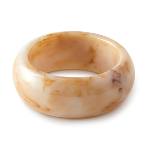 Close-up of polished amber and cream marble acrylic wide bangle with smooth finish