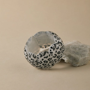 Detail of leopard print wide elastic bracelet with acrylic segments on natural stone