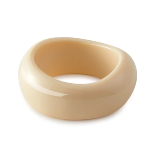 Close-up of thick beige acrylic resin bangle with a polished marble-like finish
