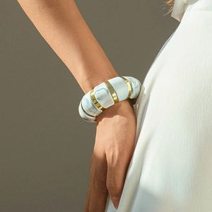 Detailed view of bohemian stretch bracelet with marble texture and gold spacers