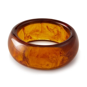 Macro detail of Bohemian semi-circular amber acrylic resin cuff with marble texture