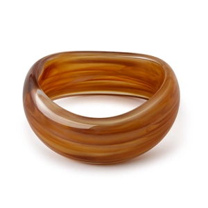 Detail of amber acrylic bangle showing marble texture and semi-transparent finish