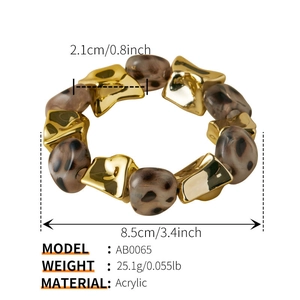Detail shot of leopard print acrylic beads and golden metal links on elastic bracelet