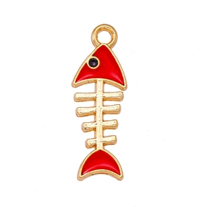 Macro detail of red fishbone charm accessory in golden alloy for DIY jewelry