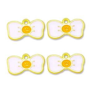 Close-up of four yellow and white alloy bow pendants with smiley face patterns