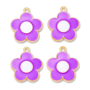 Macro detail of four purple enamel flower charms with gold plating for DIY jewelry making