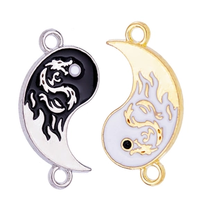 Chinese Yin Yang dragon pendants in black and white enamel with silver and gold alloy frames