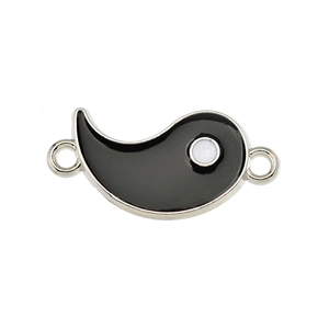 Detailed macro view of black enamel Yin Yang connector charm with silver metal base