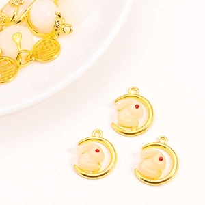 Detail of gold rabbit and moon pendant with faux Hetian jade and Fu character plate