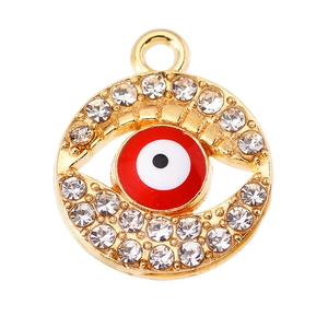Macro shot of circular evil eye pendant with gold alloy base and sparkling rhinestones