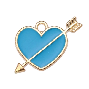 Detail of light blue heart and arrow charm with golden metal edges and hanging ring