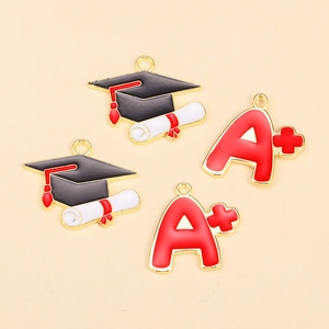 Golden alloy graduation charms featuring black mortarboard and red A+ grade symbols