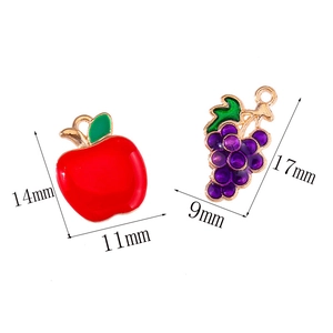 Detailed size view of red apple and purple grape charms for DIY jewelry making