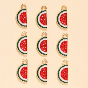 Detailed view of nine watermelon slice charms with red enamel and golden base
